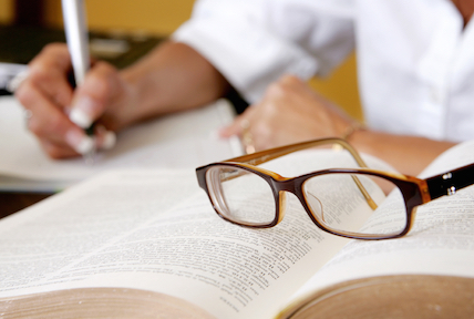 A pair of glasses resting on a book