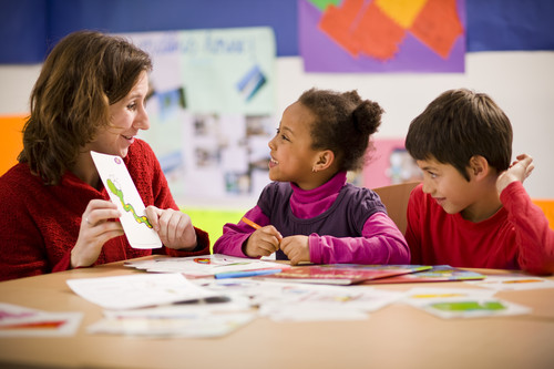 Young learner looking at flashcard