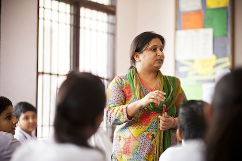 Teacher in India talking to her students