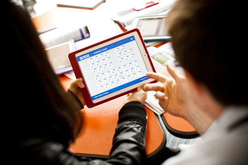 A learner and teacher looking at the phonemic chart on a tablet