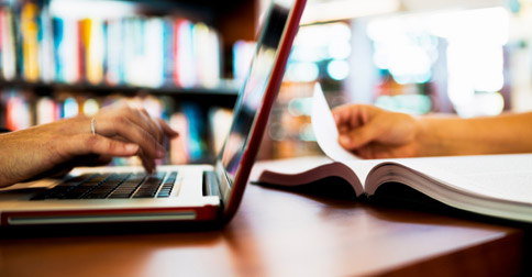 reading a computer screen and a book