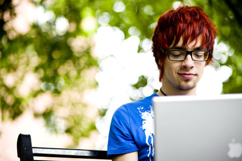 Young adult students working on his computer