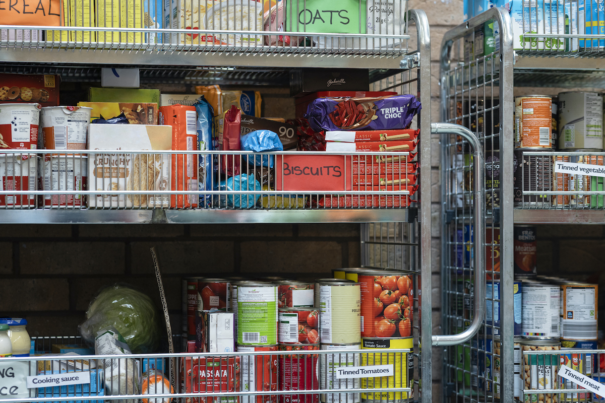 Close up of a shelving unit containing nonperishable food in storage at a food bank in the North East of England.