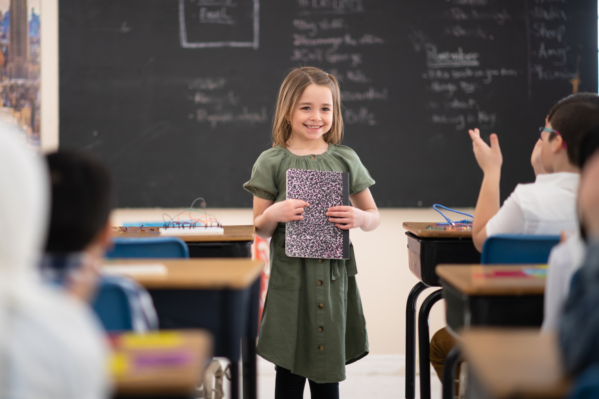 Young girl giving a presentation in class