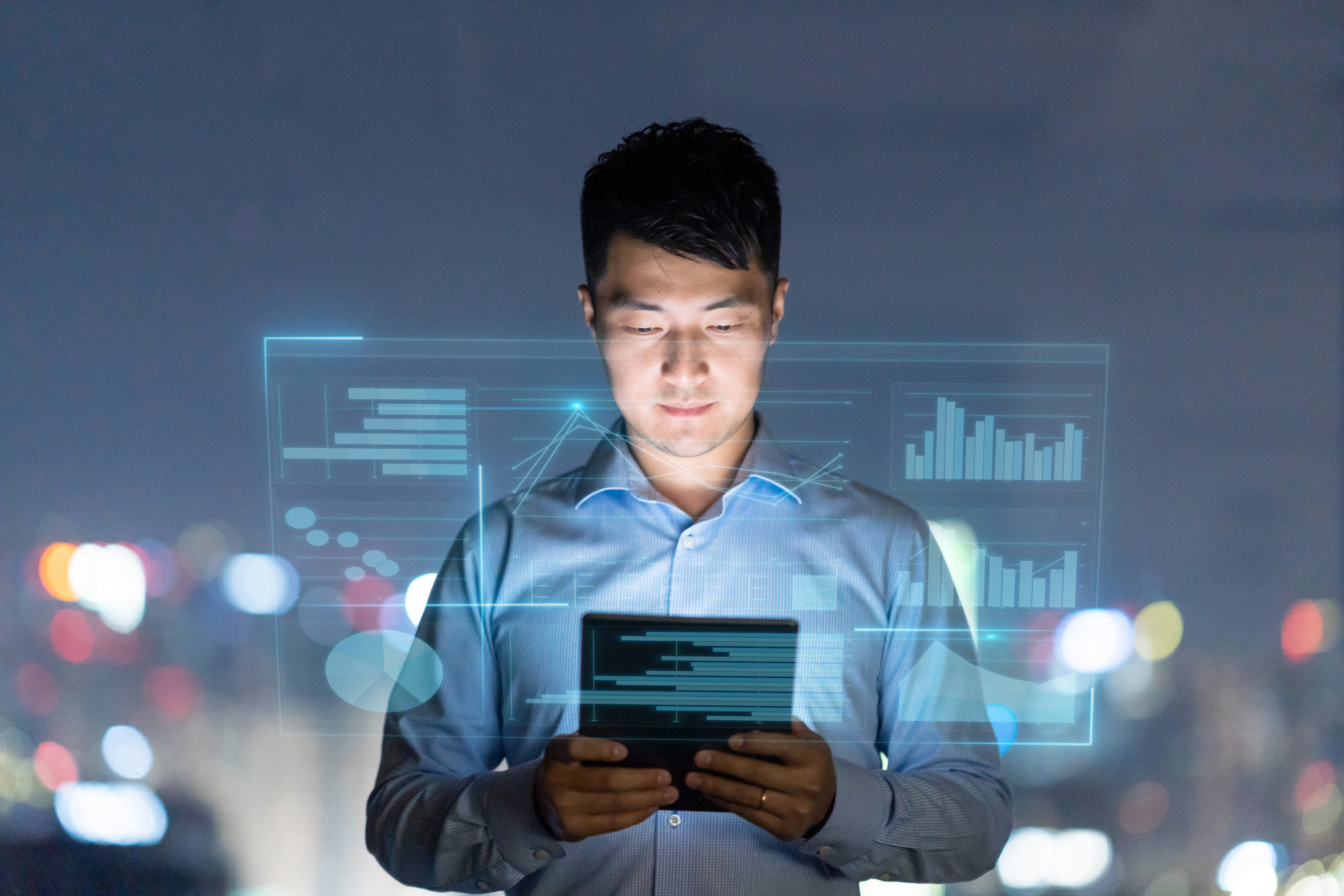 Asian man looking at a tablet with a smart screen