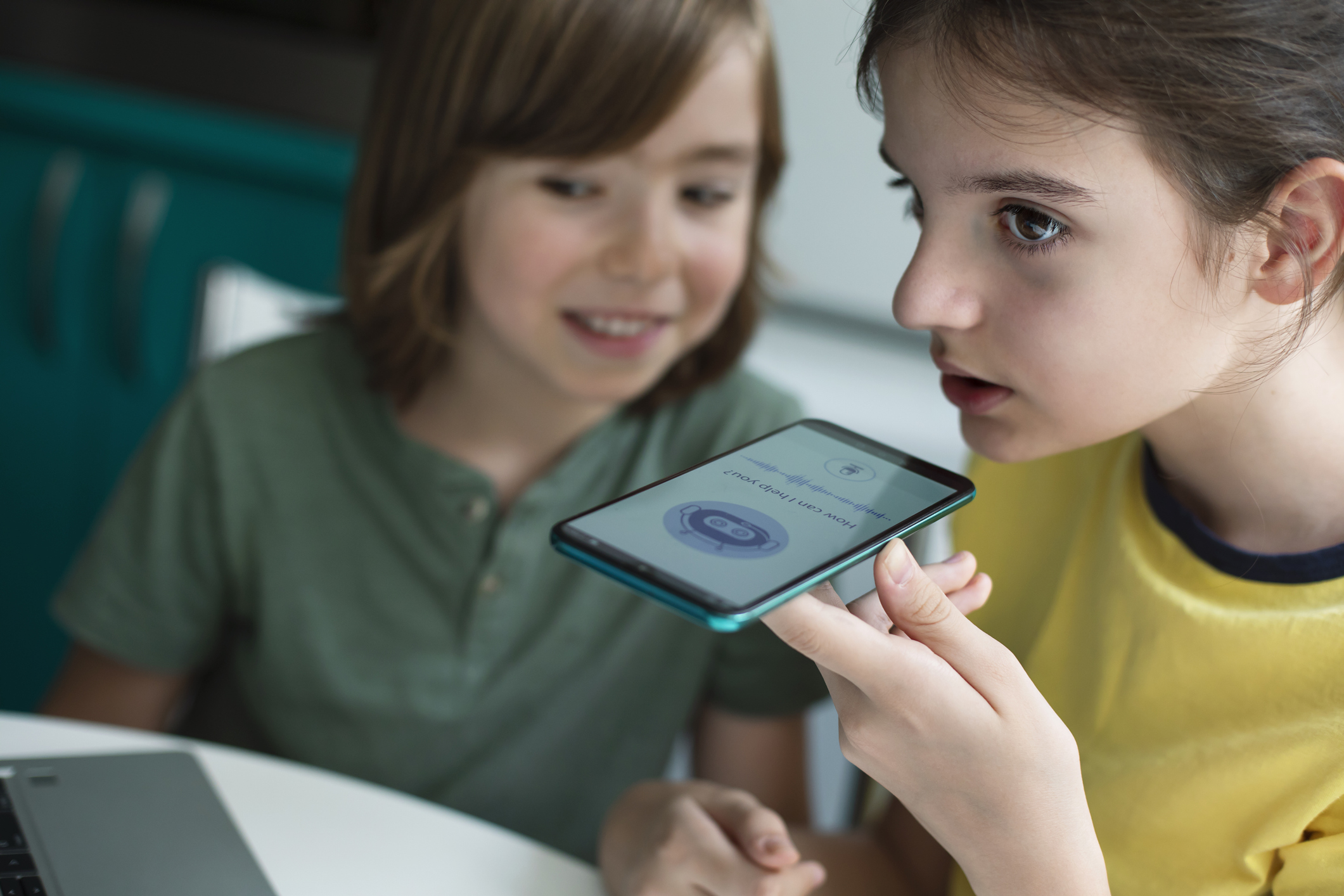 Two young learners using an AI tool in the class