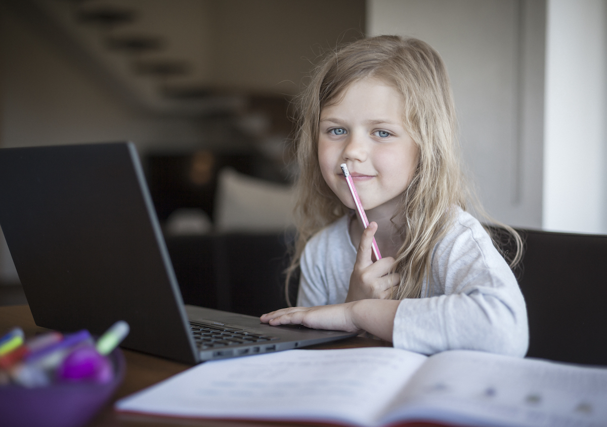 Young female student with laptop and workbook