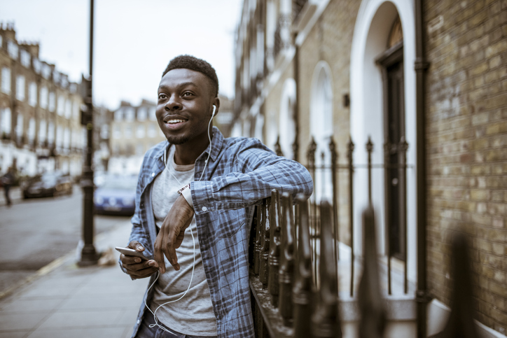 A British Jamaican man using his phone on the streets of London