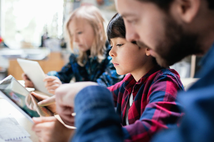 Children looking at handheld devices