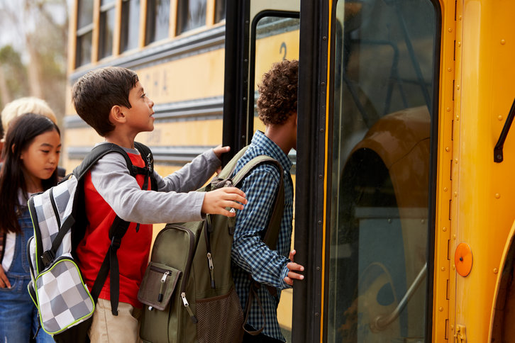 Children getting on a school bus