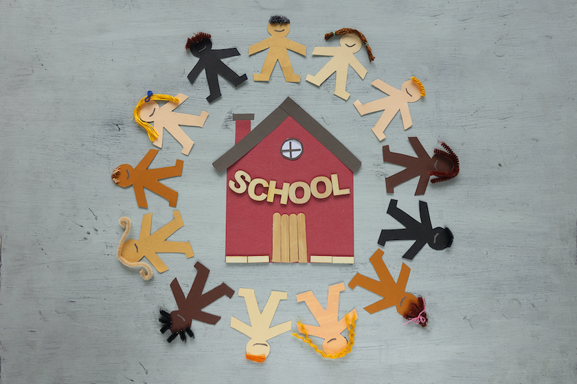 A paper chain of children around a school