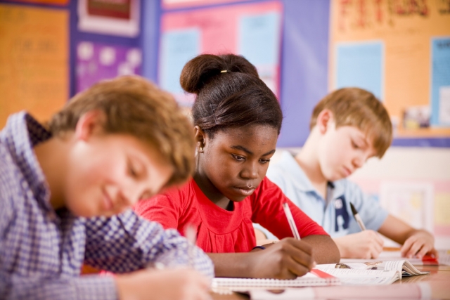 Students writing in notebooks