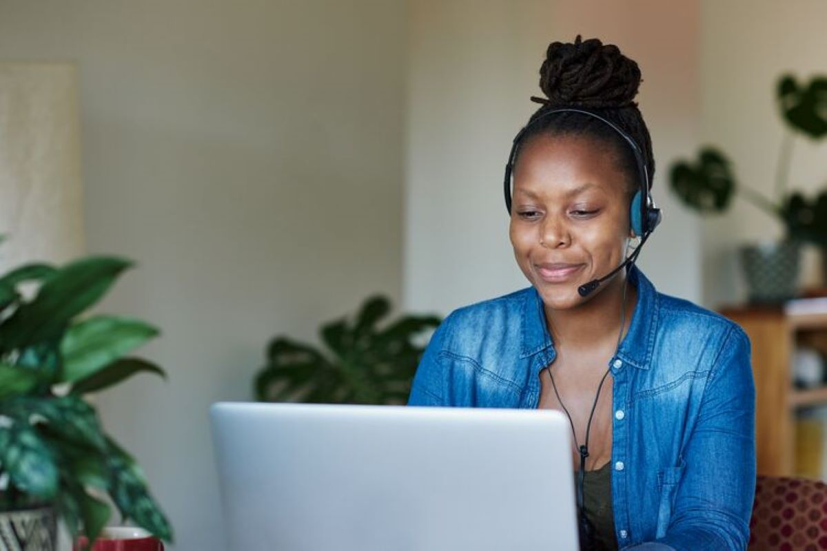 Smiling Black woman using a laptop computer