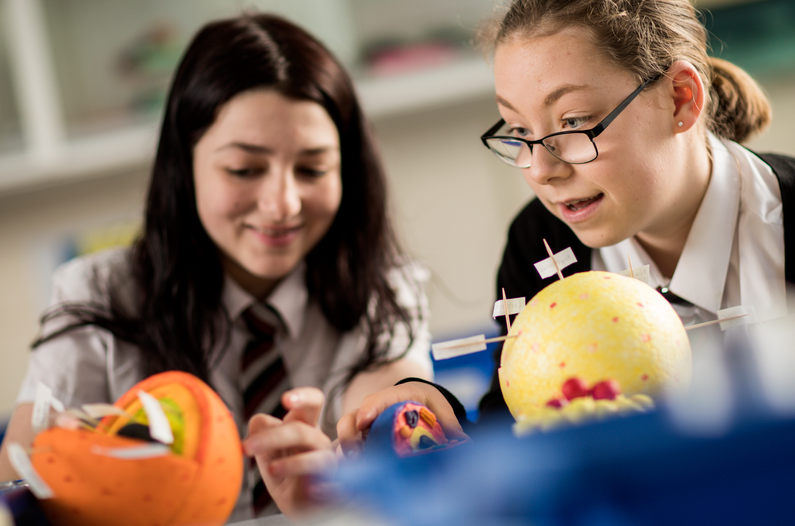 Two teens girls doing science project