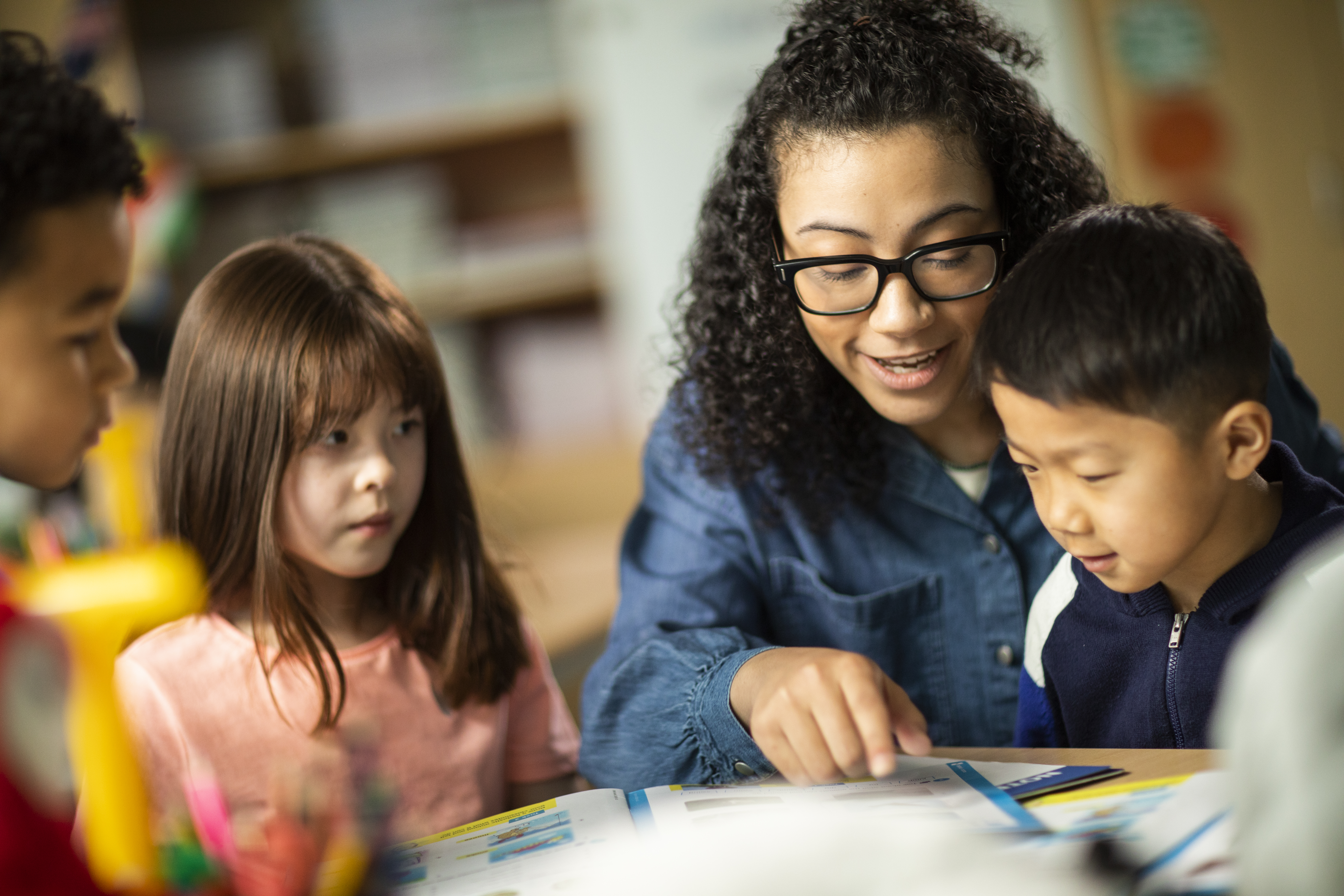 A teacher reading with some young learners