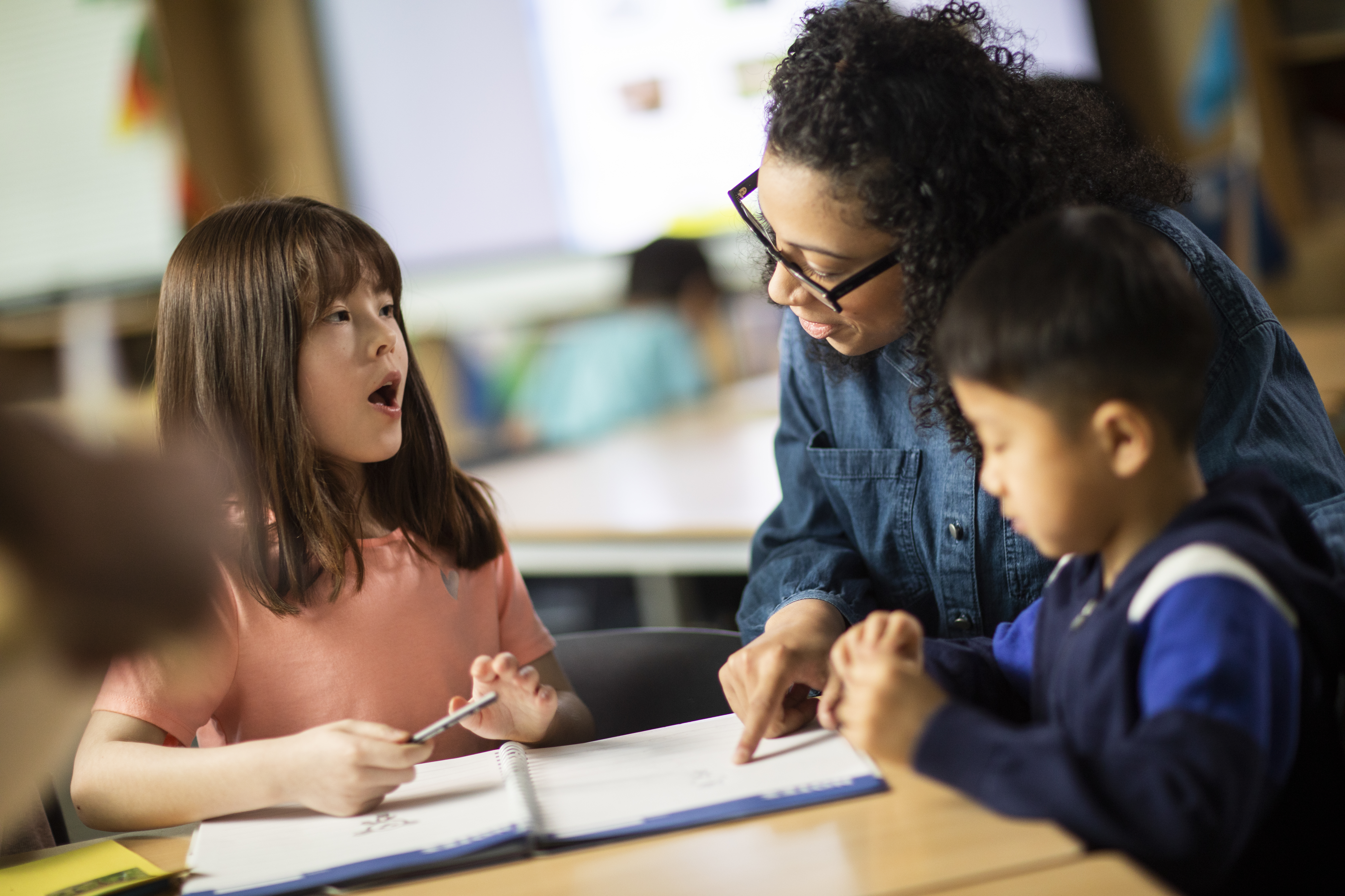 Child learning phonics with a teacher