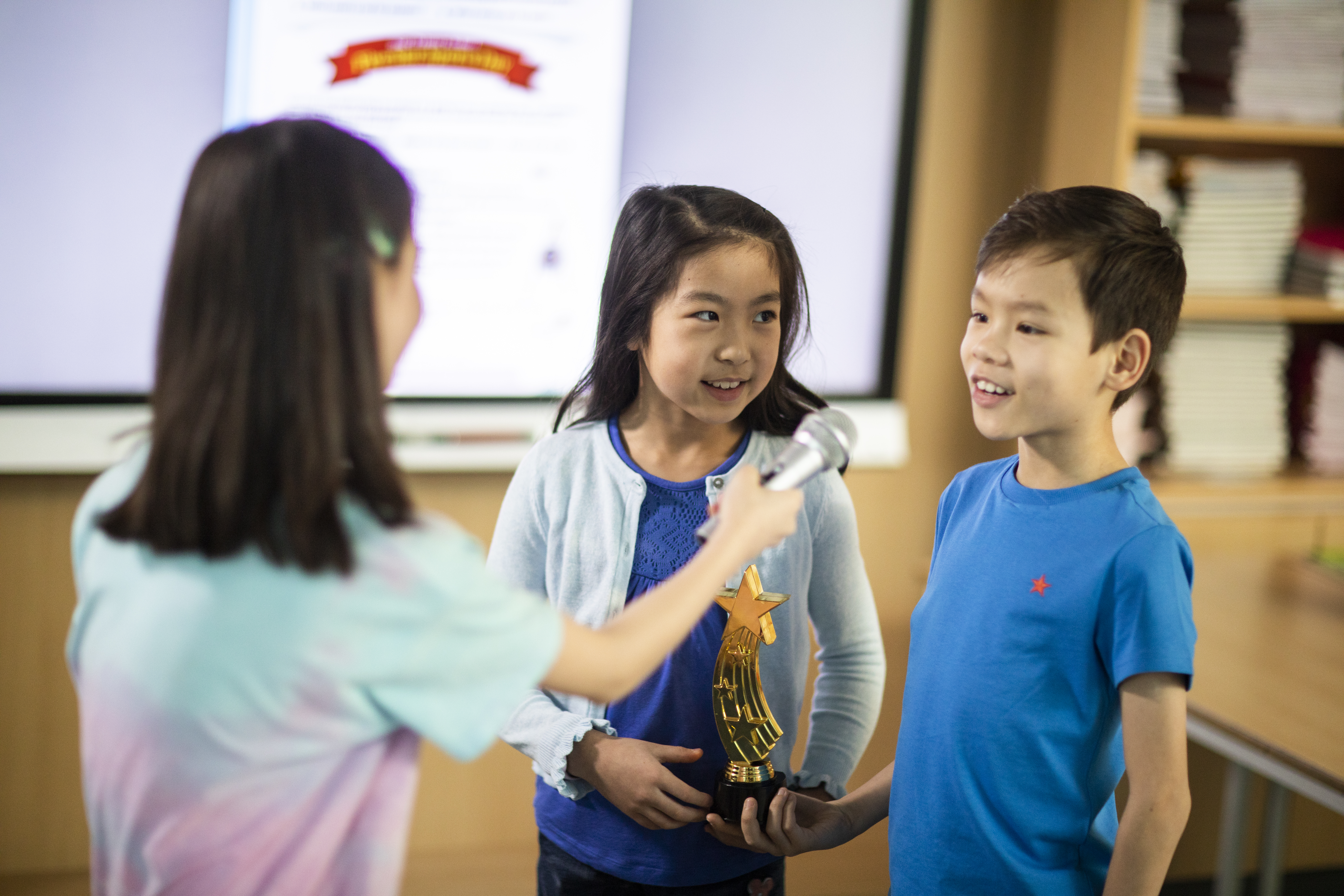 Young learners interviewing each other in class