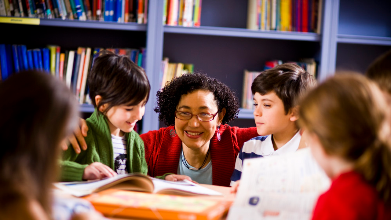 teacher smiling at young learners