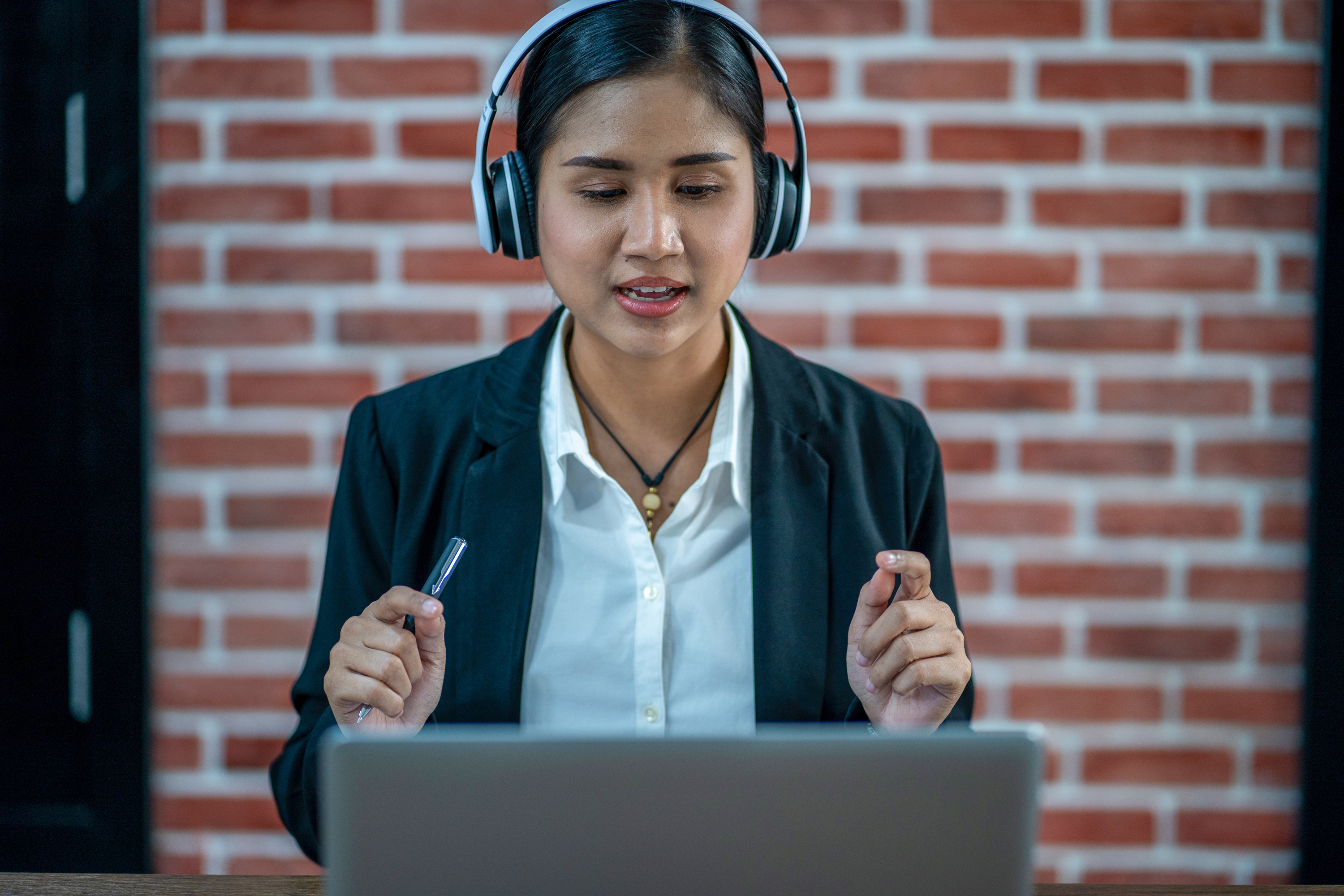 East Asian woman teacher giving a webinar