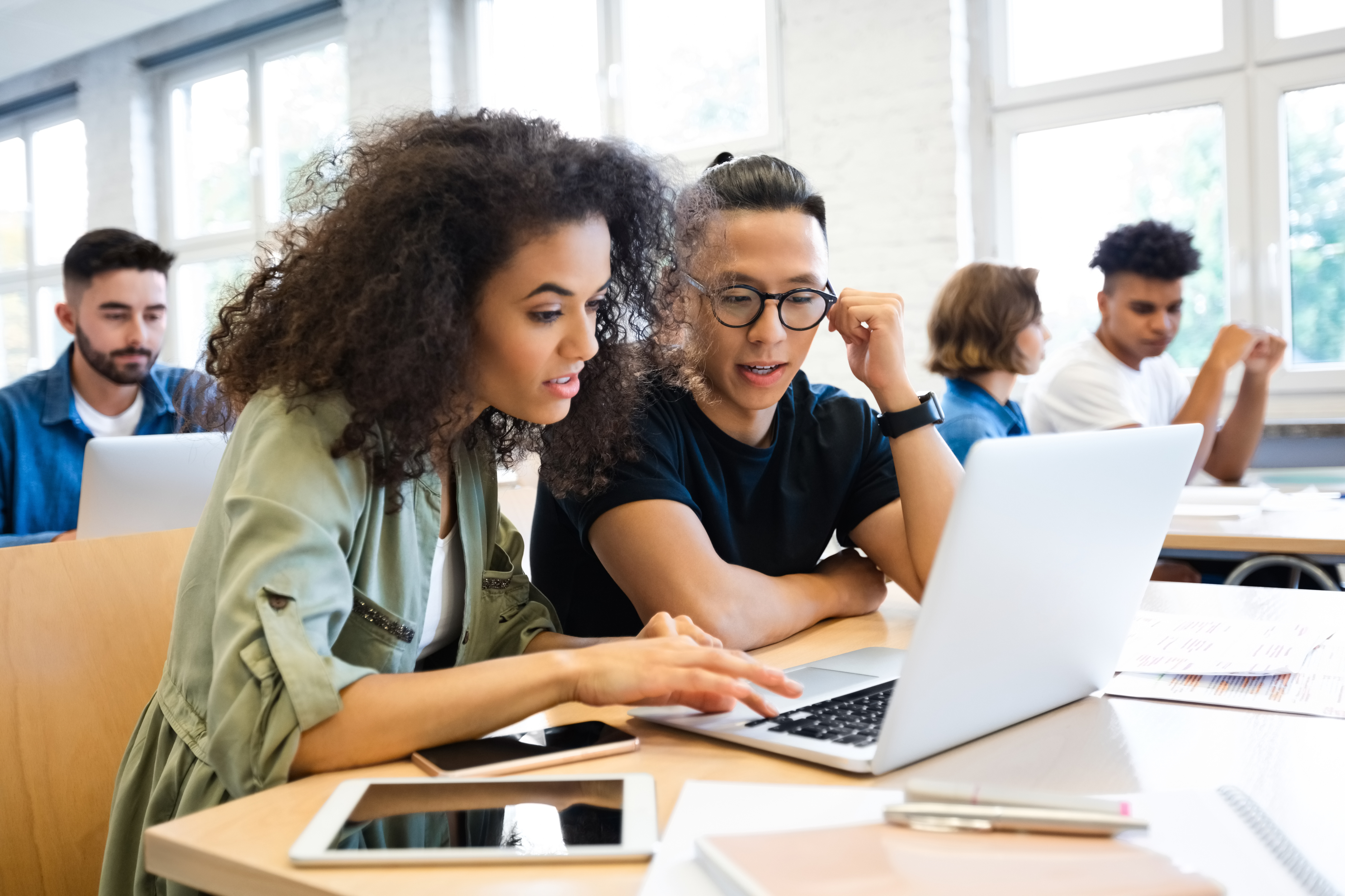 Two learners working together on a laptop