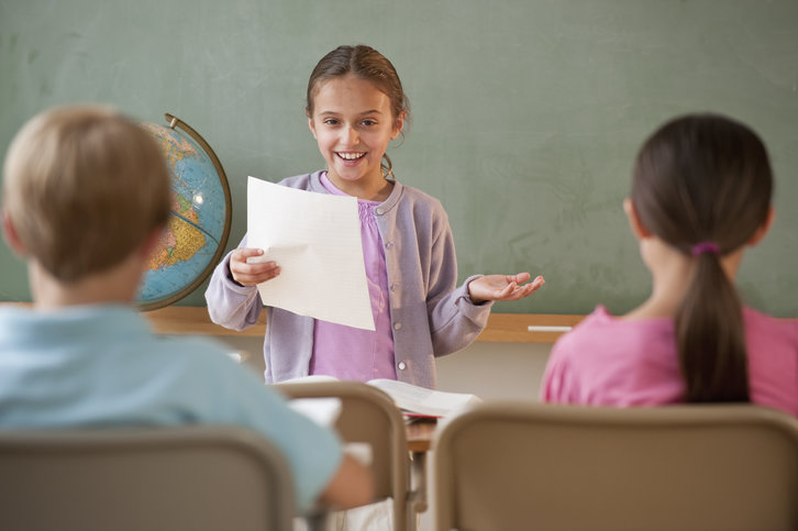 Young learner giving a presentation to the class