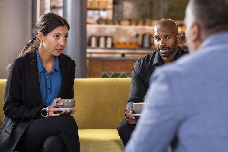 Adults chatting in a cafe