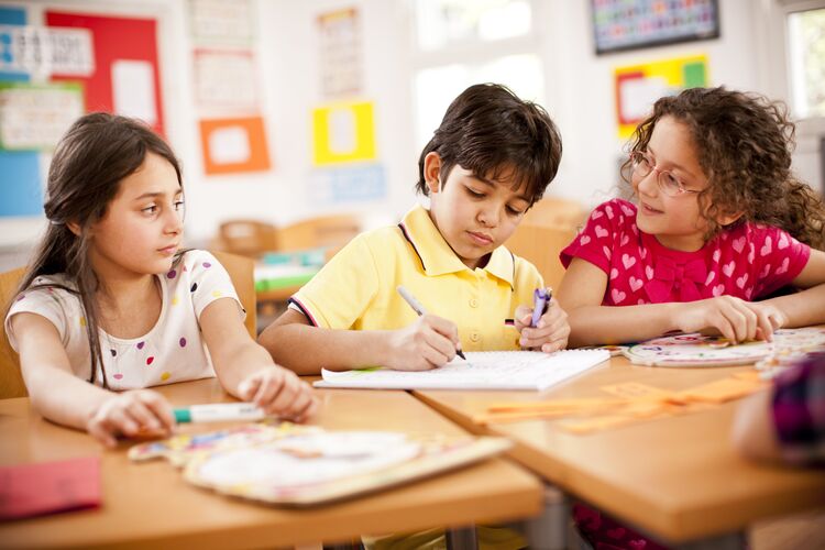 Young learners working together on a language task