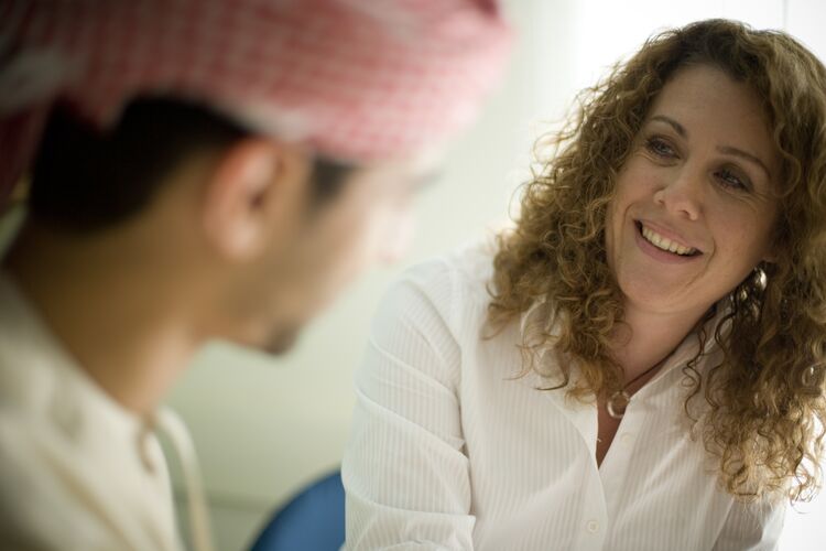 A teacher in Dubai listening to their student