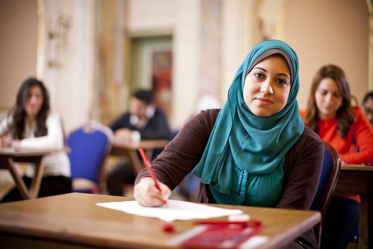 A smiling student in Egypt doing a test