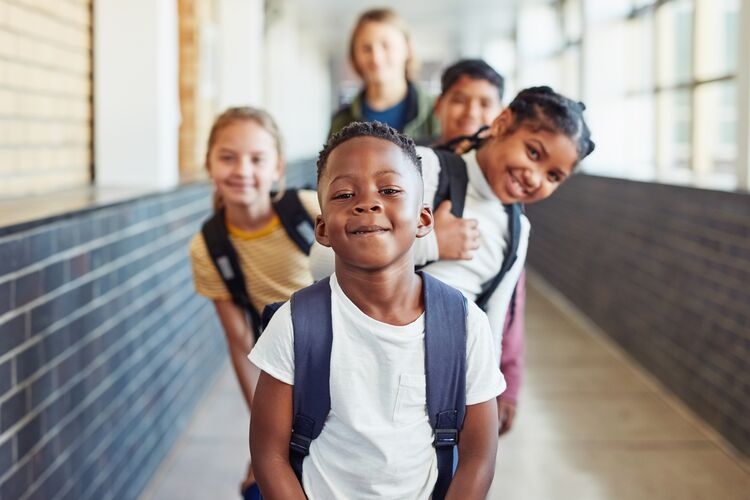 pupils in a corridor smiling