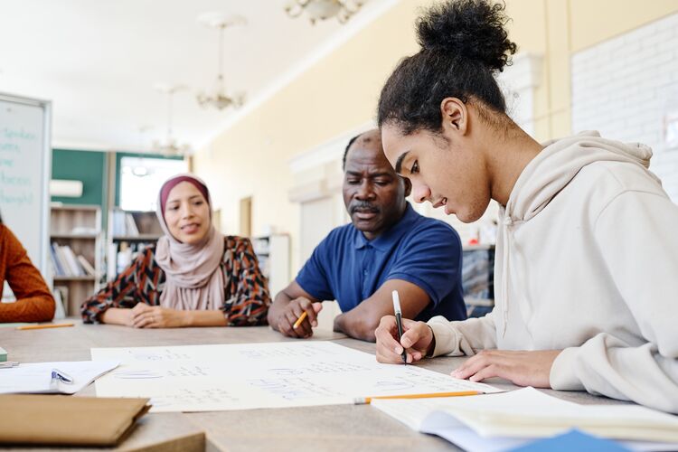 Ethnically diverse adults studying together