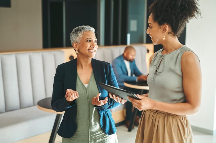 Two women talking together in a coaching session