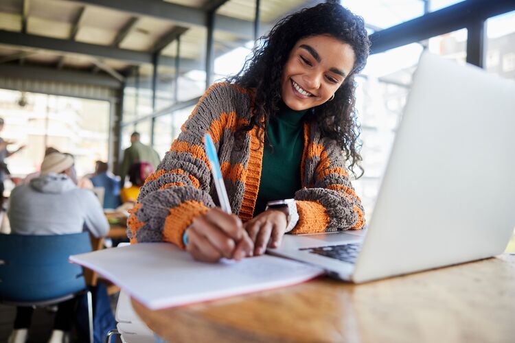 young woman studying with a laptop