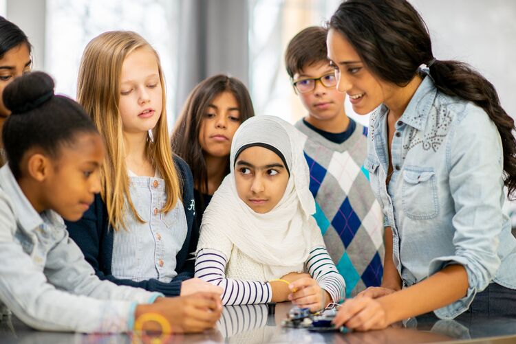 Multicultural group of students working on a science task together