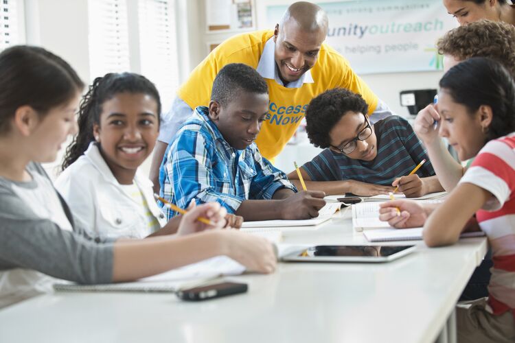 Group of diverse young learners working together in class