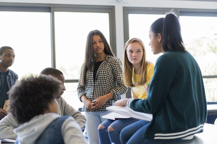 Group of international students speaking in classroom