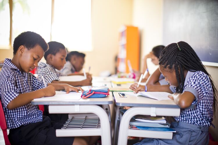 Young learners in Ghana doing a writing test