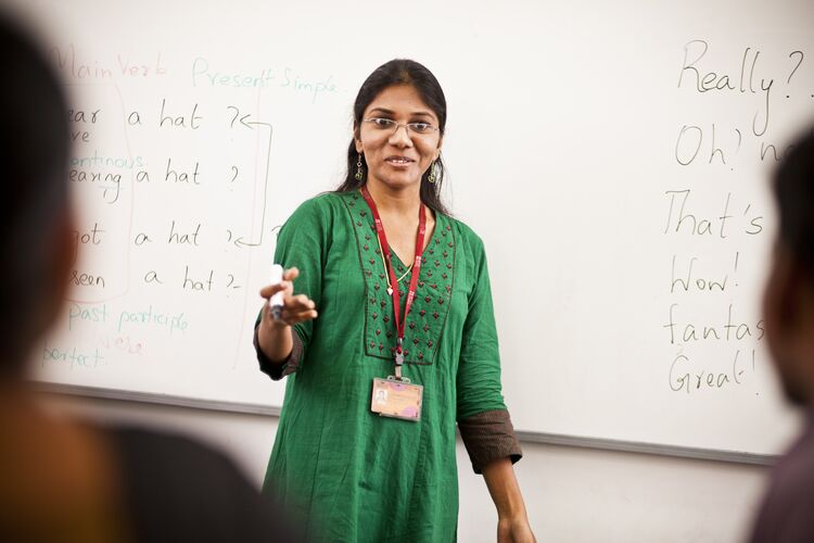 Teacher in India talking to her students