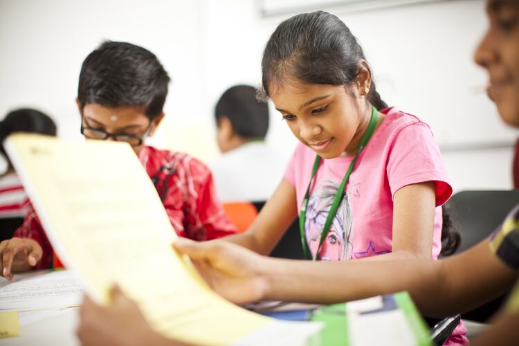 Students in India reading texts