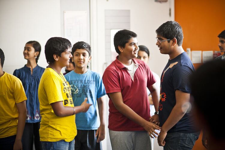 A group of students mingling in a classroom in India