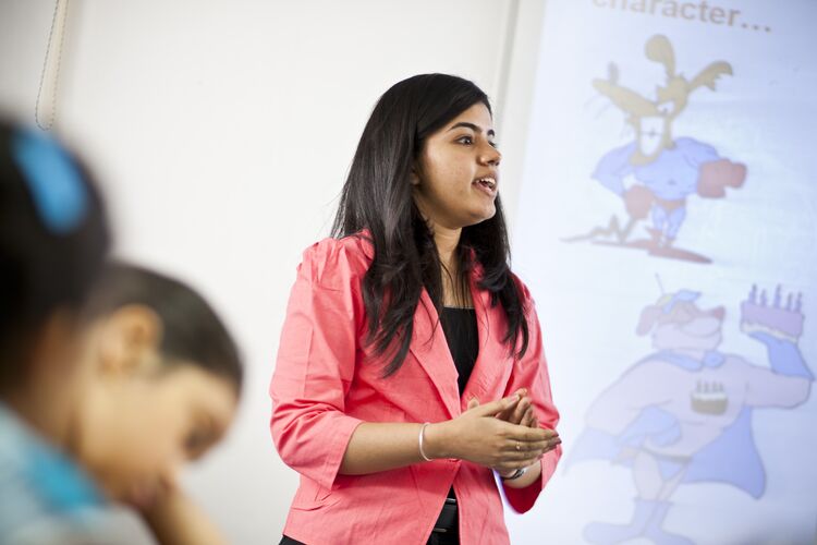 Teacher in India talking to young learners