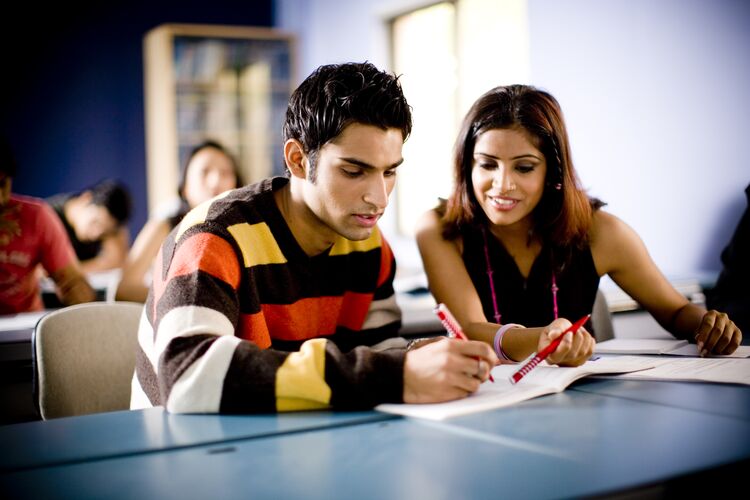 Two learners in an Indian classroom comparing notes