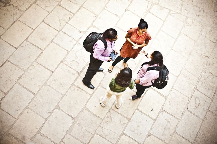 Group of students speaking in the street