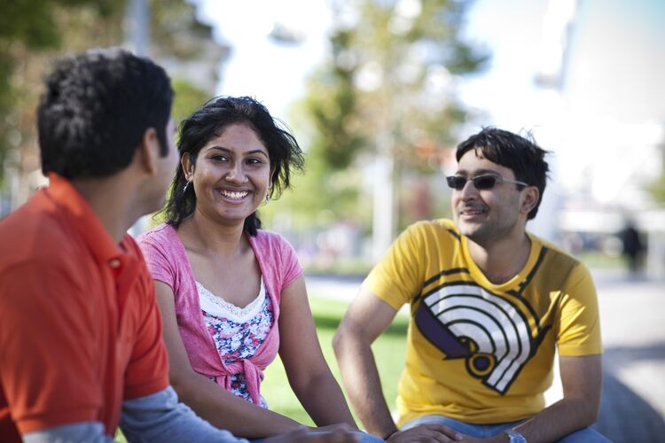 Group of Indian students sitting outside together in the UK