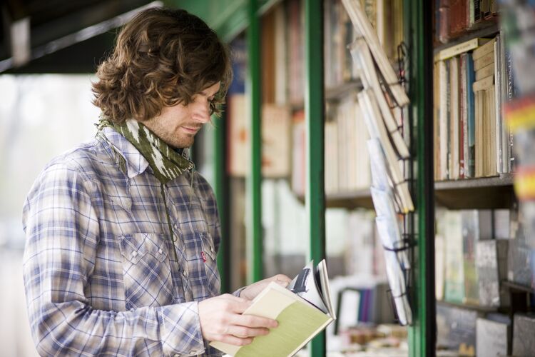 Man browsing a book at a book stall in Italy