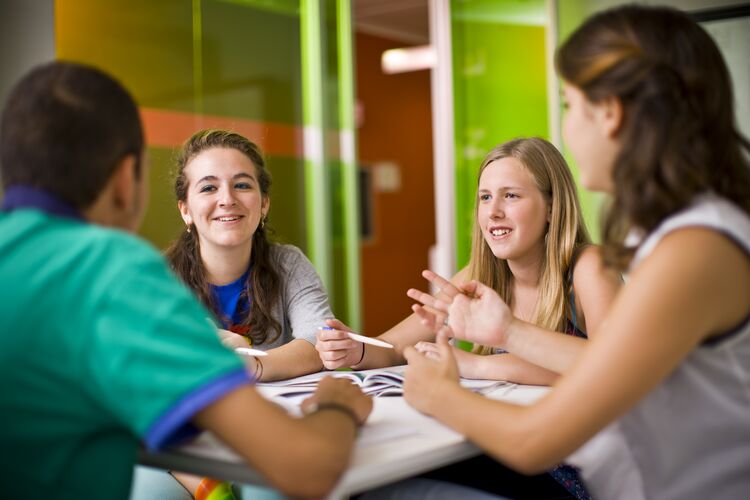 Students talking around a table