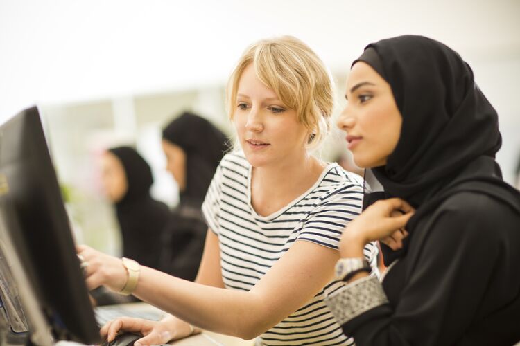 Teacher talking to Kuwaiti student