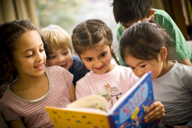 Five young children reading a picture book