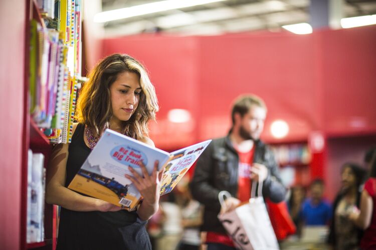 Student in Mexico reading in a library