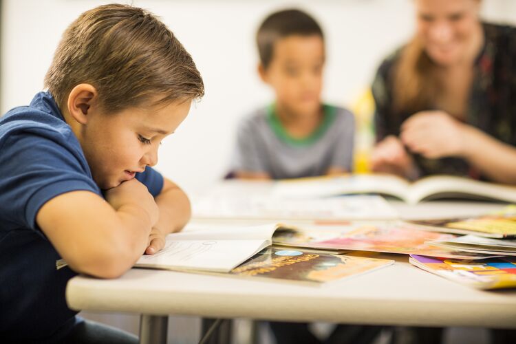 A young learner in Mexico reading a text